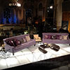 Professional event designers utilize furniture and décor on custom lit stage at Miami event